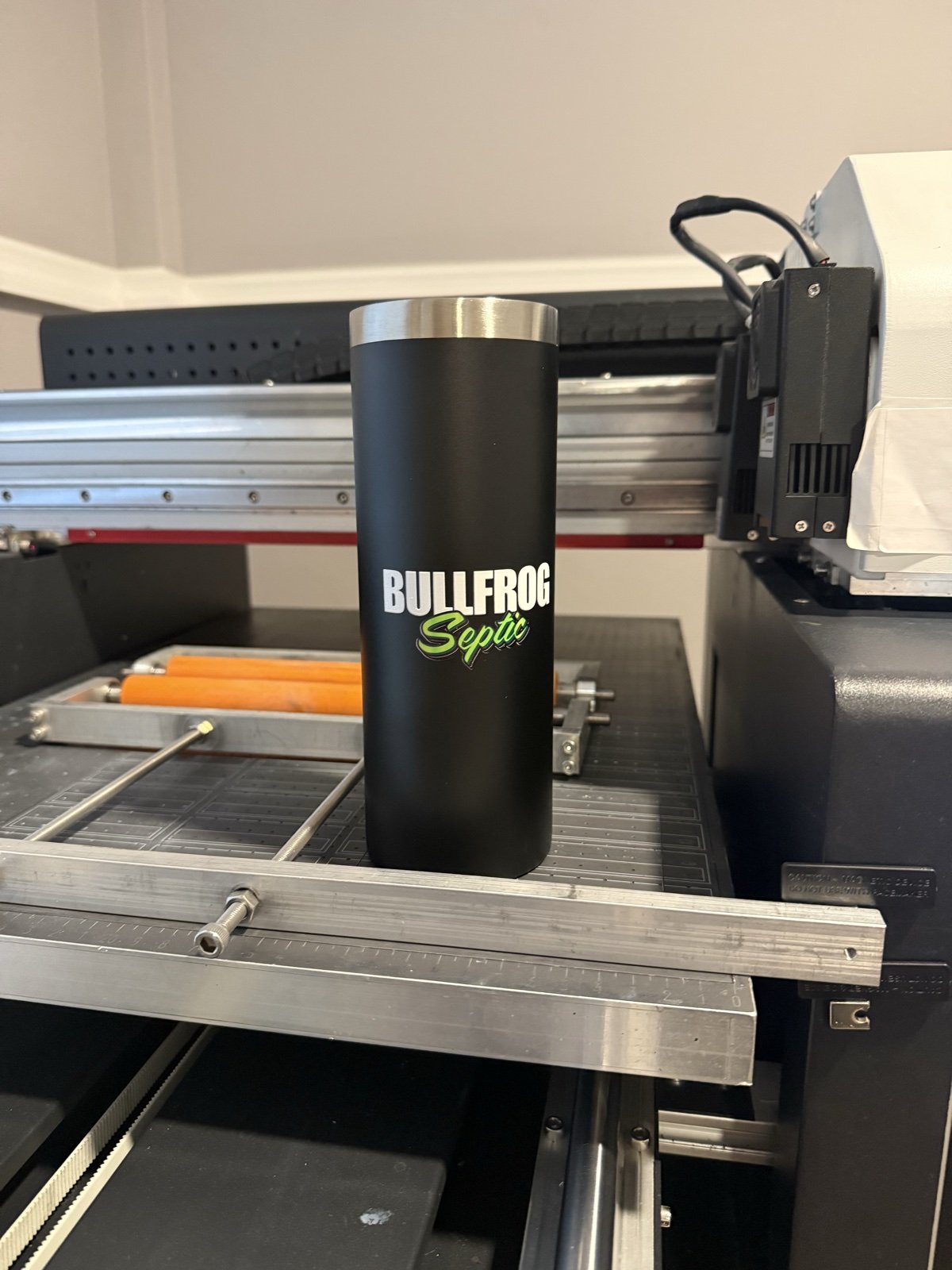 Custom logo tumbler being printed in full color in the Famgraving studio