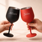 Two wine glasses, one black and one red, held by hands with names 'Allison' and 'John' engraved on them.