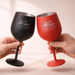 Two wine glasses, one black and one red, held by hands against a neutral background with 'Vineyard Estates' branding.