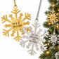 Personalized gold and silver snowflake ornaments next to a Christmas tree