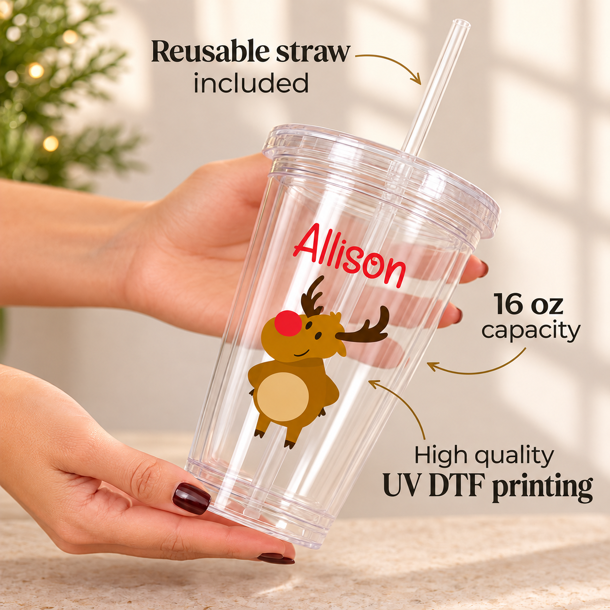 Hand holding a 16oz clear kids Christmas tumbler with a reindeer and the name Allison, UV DTF print