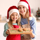 Mom and daughter holding a personalized Christmas Eve cookie board for Santa