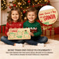 Two kids holding a Santa cookie tray with up to 4 names on one board